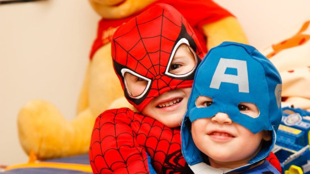 Two young boys in superhero costumes