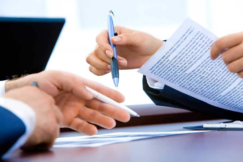 Close up of a man's hands and a woman's hands in the office